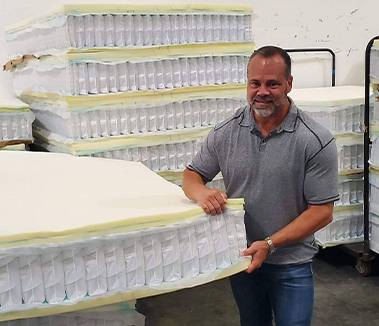 Owner Richard Branham with mattresses in the Panama City warehouse