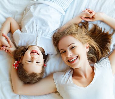 Mother and daughter relaxing on a new mattress