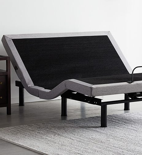 Adjustable bed base raised in a bedroom